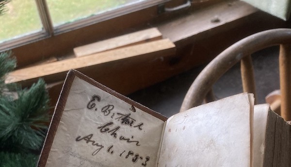 a book opened to a page with the date 1853 visible