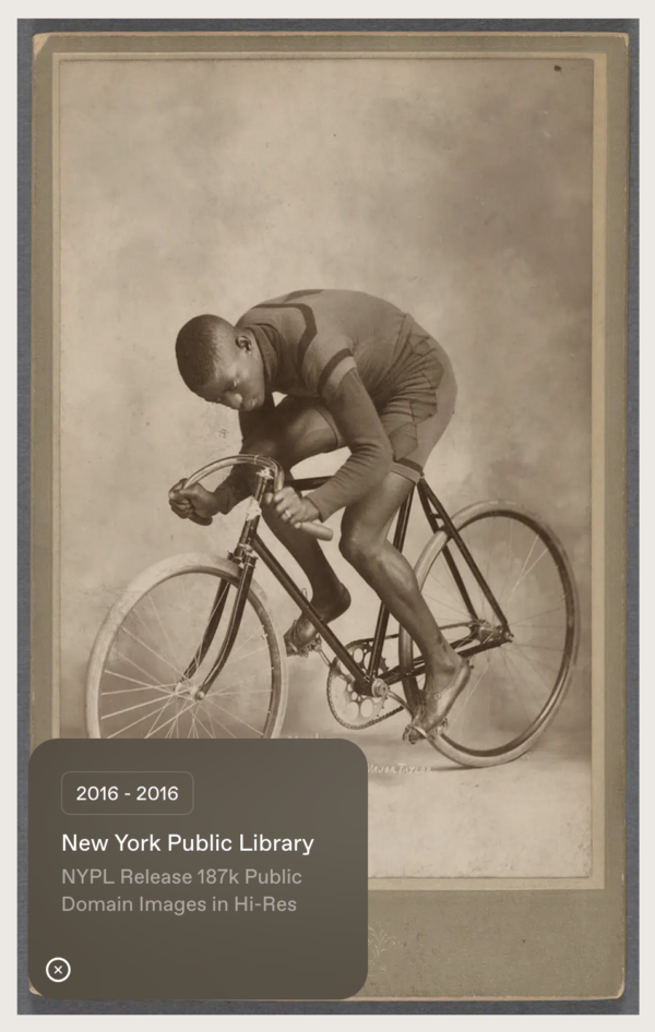 A black man riding a racing bicycle in a studio portrait